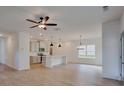 Bright, open floor plan showcasing the kitchen with island and a view to the living and dining spaces at 3006 Sea Aster Way, Buford, GA 30519