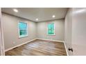 A serene bedroom with two windows and new floors at 336 Shady Lane Cir, Canton, GA 30115