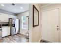 Hallway featuring white walls, hardwood floors, and stainless steel appliances at 3999 Bayside Cir, Doraville, GA 30340