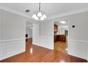 Bright dining room with hardwood floors, crown molding, and elegant chandelier lighting at 4009 Riverstone Dr, Suwanee, GA 30024