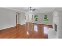 Bright living room with hardwood floors, fireplace, and views of the front yard at 4009 Riverstone Dr, Suwanee, GA 30024