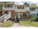 Cozy townhome featuring a brick facade and a welcoming front porch at 6991 Flagstone Dr, Austell, GA 30168