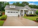 Charming single Gathering home with a lush front yard and a two-car garage at 219 Cordova St, Woodstock, GA 30189