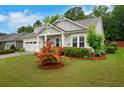 Charming single Gathering home with a lush front yard and a two-car garage at 219 Cordova St, Woodstock, GA 30189