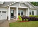 The gray craftsman-style home features a charming covered porch at 219 Cordova St, Woodstock, GA 30189