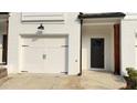 Inviting townhouse facade with a white garage door and modern design at 32 S Auburn Landing Pl, Auburn, GA 30011