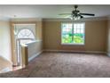 Bright living room featuring plush carpeting, ample natural light, and neutral paint colors at 4527 Berline Dr, Lithonia, GA 30038
