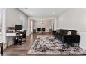 Open living room with wood floors, and large windows that bring in lots of natural light at 4147 Pinehurst Valley Dr, Decatur, GA 30034
