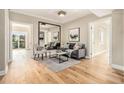 Inviting living room with hardwood floors, a large mirror, and access to a balcony at 587 Virginia Ne Ave # 609, Atlanta, GA 30306