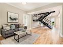 Bright living room featuring hardwood floors, modern decor, and an industrial staircase at 587 Virginia Ne Ave # 609, Atlanta, GA 30306