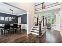 Open foyer showcasing hardwood floors, staircase, and a view into the dining and living areas at 650 Garden Wilde Place, Roswell, GA 30075