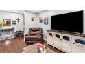 Cozy living room with dark laminate floors and entertainment center at 6628 Londonderry Dr, Morrow, GA 30260