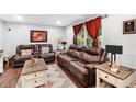 Comfortable living room with leather seating, soft rug and natural lighting at 6628 Londonderry Dr, Morrow, GA 30260