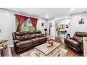 Living room showcases warm seating, natural light, and new laminate flooring at 6628 Londonderry Dr, Morrow, GA 30260