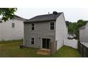 View of backyard with newly installed sliding glass doors and wood privacy fence at 176 Silver Fox Trl, Dallas, GA 30157