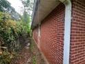 Brick home with greenery around the exterior and small windows at 301 Sisson Ne Ave, Atlanta, GA 30317