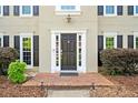 Welcoming front entrance showcasing a classic door, sidelights, and manicured landscaping for an inviting curb appeal at 4780 Agate Dr, Johns Creek, GA 30022