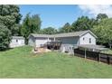 Expansive backyard with a wooden deck, storage shed, and car port, offering ample outdoor space at 8321 Banks Mill Rd, Douglasville, GA 30135