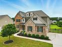Beautiful home with brick and siding exterior, manicured lawn, and a driveway leading to a rear-entry garage at 847 Rolling Hill, Kennesaw, GA 30152