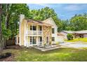 Two-story home with a stone facade, covered porch, attached garage, and lush green lawn at 2568 Redfield Dr, Norcross, GA 30071