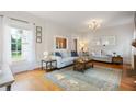 Bright living room featuring hardwood floors, neutral decor, and large windows providing natural light at 67 Trammell Sw St, Marietta, GA 30064