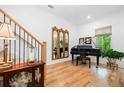 Elegant entryway with hardwood floors, decorative mirror, piano and staircase with iron railings at 1045 Endeavour Ct, Marietta, GA 30064