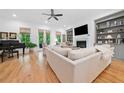 Bright living room featuring a fireplace, TV, built-in shelving and hardwood floors at 1045 Endeavour Ct, Marietta, GA 30064