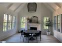 Bright dining room with cathedral ceiling, shiplap, modern light fixture and views of the backyard at 1303 Cobblemill Nw Way, Kennesaw, GA 30152