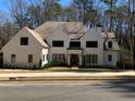 An impressive exterior view of a modern home with a manicured lawn and beautiful landscaping at 1303 Cobblemill Nw Way, Kennesaw, GA 30152