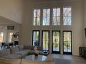 Spacious living room boasts high ceilings, large windows, and a cozy sofa at 1303 Cobblemill Nw Way, Kennesaw, GA 30152