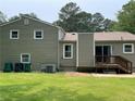 The back exterior of this home has a deck and a large grassy yard at 3100 Karen Ne Ln, Marietta, GA 30062