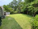 Large, private backyard featuring lush green lawn and mature trees at 3100 Karen Ne Ln, Marietta, GA 30062