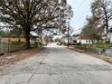 A wide street view of the neighborhood with mature trees and various home styles at 701 Cameron M Alexander Nw Blvd, Atlanta, GA 30318