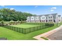 Spacious, fenced dog park area within a well-manicured lawn, ideal for pet owners at 1315 Aura Ln, Lawrenceville, GA 30045