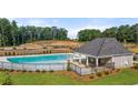Community swimming pool with shaded patio, offering a refreshing retreat for residents at 1315 Aura Ln, Lawrenceville, GA 30045