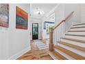 Bright foyer featuring hardwood floors, staircase, and a view into the living spaces at 313 Sisson Ne Ave, Atlanta, GA 30317