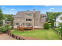 Expansive backyard showcases a well-maintained lawn, privacy fence, and mature landscaping at 4530 Westgate Dr, Cumming, GA 30040
