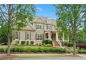 Charming two-story home framed by mature trees and lush greenery at 4530 Westgate Dr, Cumming, GA 30040