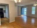Open-concept living area with hardwood floors connecting to the kitchen and front entrance at 109 Ivy Crest Dr, Dallas, GA 30157