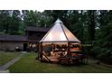 Backyard featuring a modern gazebo, an inviting deck area, and an enchanting string lights at 4567 Town Crier Sw Rd, Lilburn, GA 30047