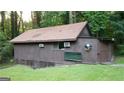 Quaint house with unique windows complemented by a grassy yard at 4567 Town Crier Sw Rd, Lilburn, GA 30047