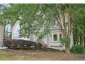 A two-story home nestled among trees features bay windows and mature landscaping at 220 Chinkapin Sw Cir, South Fulton, GA 30311