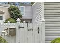 Exterior of cozy townhome featuring white picket fence with stylish black accents at 2694 Greentree Se Dr, Marietta, GA 30067