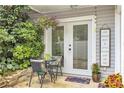 Outdoor patio featuring table and chairs and well-maintained landscaping providing a welcoming space at 2694 Greentree Se Dr, Marietta, GA 30067