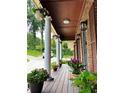 Inviting front porch adorned with hanging plants and colorful potted flowers, creating a warm welcome at 4807 Greenway Rd, Norcross, GA 30071