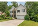 Inviting two-story home featuring a well-manicured lawn and a two-car garage at 3801 Stonebriar Ln, Duluth, GA 30097