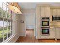 Bright kitchen area featuring stainless steel double oven and hardwood floors at 460 Chowning Nw Pl, Marietta, GA 30064