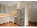 Modern kitchen with stainless steel refrigerator and white cabinets at 460 Chowning Nw Pl, Marietta, GA 30064