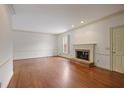 Bright living room with hardwood floors and a cozy brick fireplace at 460 Chowning Nw Pl, Marietta, GA 30064