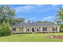 Beautiful home featuring a well-manicured lawn and classic architectural details at 2265 Colony Dr, Canton, GA 30114